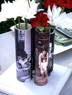 three vases with red and white flowers in them sitting on a table next to each other