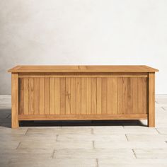 a large wooden box sitting on top of a tile floor next to a white wall