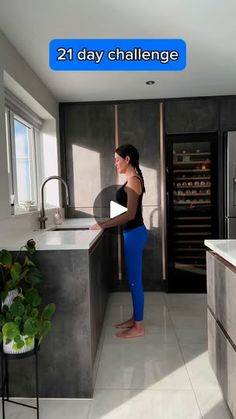 a woman standing in a kitchen next to an oven and counter top with the words 21 day challenge on it