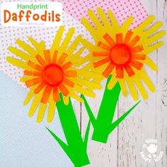 paper flowers made with construction paper on a white wooden background and text that reads handprint daffodils