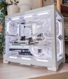 a white computer case sitting on top of a wooden desk