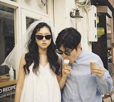 a bride and groom are eating ice cream