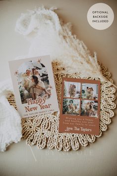 two christmas cards sitting on top of a doily next to a pile of yarn