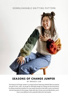 a woman sitting on top of a wooden chair holding a knitted heart in her hands