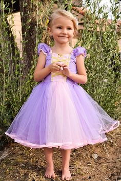 "RAPUNZEL costume, Rapunzel dress, Rapunzel TUTU dress, Lavender dress SIZES- 6/12m, 18/24, 2/3T, 4/5T, 6/6x 7/8 and 10/12 READY TO SHIP This Rapunzel dress is a must for your princess party. This is the TUTU dress version of my sweetheart dress. This dress is made of a soft cotton poly blend fabric. The skirt is layered with purple colored tulle with a pink strip in the center of the front skirt. The front has a sweetheart neckline with pink inset. The inset is trimmed with gold metallic ribbon Pink Princesscore Dress For Halloween, Lavender Fitted Princess Dress For Dress-up, Pink Princess Fairy Dress For Costume Party, Princess Style Fairy Dress With Ruffles For Costume, Princess Costume With Ruffles For Fancy Dress, Cute Pink Princess Dress Costume, Pink Princess Dress For Costume Party, Pink Princesscore Dress For Costume Party, Pink Princess Style Tutu Dress For Fancy Dress