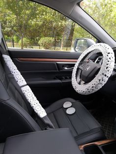 the interior of a car with a steering wheel cover