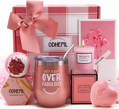 a pink gift box with candles, soap and other items