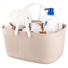 a pink basket with bottles and soaps in it, on a white background that is also used as a caddy