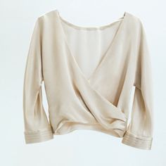 Top With Elbow-Length Sleeves And Pleated Cuffs. Crossed V-Neckline At Back. Side Hidden In-Seam Zip Closure. Elegant V-neck Blouse For Brunch, Cream V-neck Top For Work, Elegant Stretch V-neck Top For Fall, Chic Beige Wrap Top, Elegant Long Sleeve Wrap Top For Work, Formal Wrap Top For Fall, Spring Formal Wrap Top, Formal Fall Wrap Top, Beige V-neck Top For Work