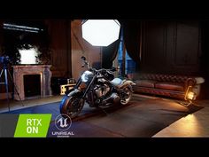 a motorcycle is parked in the middle of a room with lights on and behind it