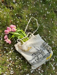 pink tulips in a bag on the ground