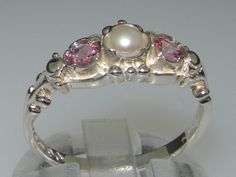 "This stunning Georgian Inspired Trilogy design is made to order and handset with a centre cultured freshwater pearl measuring 4.25mm (0.17\") and two round cut natural Pink Tourmaline gemstones measuring 3.5mm (0.14\").   The gemstones are natural, earth-mined and ethically sourced Your ring will be fully tested and hallmarked by the London or Birmingham Assay Office giving you the assurance of a high quality piece to wear and treasure FOR UK, AUSTRALIAN, EUROPEAN & NON-US BUYERS :  If you know Trilogy Ring, Pearl Pink, Funky Jewelry, Jewelry Lookbook, Pretty Rings, Jewelry Inspo, Dream Jewelry, Silver Pearls, Gold Pearl