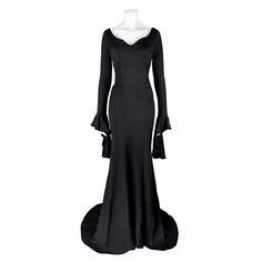 a black evening gown with long sleeves and ruffles on the shoulders, in front of a white mannequin