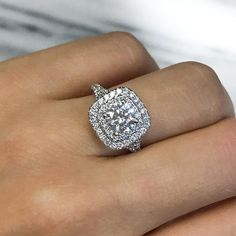 a woman's hand with a diamond ring on it