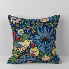 a red pillow with birds and flowers on it