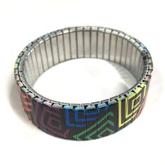 "Stretch bracelet with a rainbow square design. The art is \"baked\" into each bracelet making it very durable. Wrist-Art is made using a comfortable repurposed stainless steel watch band it will never rust and is generally considered hypoallergenic for most people. If you don't see your size in the preset list simply add the size of your wrist in the \"Notes\" section when you place your order. PLEASE NOTE: -The bracelet is more comfortable when it is a bit loose. -It will also stretch easily o Adjustable Multicolor Stainless Steel Bracelets, Bracelet Rainbow, Steel Gifts, Wrist Band, Steel Watch, Stainless Steel Watch, Square Design, Long Beach, Stretch Bracelet