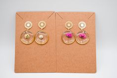 - Handmade epoxy resin earrings with real dried pressed white, pink, yellow, or orange Gypsophila hanging from a stylish stud earring. Studs are hypoallergenic and made from 18K Gold Plated Stainless Steel.  - Each piece is cured for 72 hours in a temperature controlled environment to prevent scratches, scuffs, yellowing, or other damage. Buffed and polished to create a beautifully smooth finish that shines in the light!  - Due to the natural variety in flowers and the handmade nature of the jewelry, there may be a slight variation in each item.  - Each pair comes in lightweight, protective packaging to reduce environmental harm and minimize your cost of shipping.  - If you have any questions or concerns regarding this item, please feel free to send me a message. I am happy to create custo Epoxy Resin Earrings, Flower Dangle Earrings, Jewelry Bridesmaid, Earring Studs, Orange Flower, Earrings White, Baby's Breath, Earrings Wedding, Resin Earrings