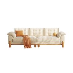 a white couch sitting on top of a wooden floor next to a brown throw pillow