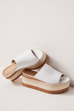 Stack it up with these mega flatform sandals from Paloma Barcelo, featuring a thick leather toe strap and a tonal striped sole. **Features:** Slip-on style, backless design, thick leather toe strap, round open toe, flatform sole with striped details, rubber outsole **Why We | High Standards Flatform Sandals by Paloma Barcelo at Free People in White, Size: EU 39 Modern Sandals With Contrast Sole For Summer, Modern Leather Sandals With Thick Bottom, Summer Sandals With Contrast Sole And Open Toe, Summer Open Toe Sandals With Contrast Sole, Modern White Wedge Sandals With Chunky Platform, Beach Leather Platform Slide Slippers, White Closed-toe Platform Slippers For Beach, White Non-slip Open Toe Platform Slippers, White Platform Slip-on Sandals