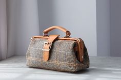 "Doctor Bag is my favorite  handbag, This time, I use Italian cowhide leather and canvas to make the shoulder bag, the long shoulder strap is attachable, so, you can use it as side bag, purse, top handle bag or small handbag. The bag is made with  herringbone Harris Tweed, it is lined with patterned cotton. Product Description * Material: wool+ vegetable tanned leathe * Color: honey *  Flap over entry with snap button closure   * wide canvas shoulder strap adjust from 0\" to 47\" * one inside op Long Strap Purse, Tweed Purse, Every Day Carry, Vegetable Leather, Strap Purse, Side Bag, Women Crossbody Bag, Favorite Handbags, Doctor Bag