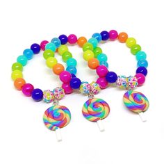 These adorable bracelets are the perfect favor for your little one's candy themed party! Each bracelet features a bright rainbow swirl clay lollipop charm, resin rhinestone beads and an assortment of bright rainbow 10mm acrylic beads strung with durable stretch cord. Each bracelet will arrive individually packaged in organza bags. Please select the number of bracelets and bracelet size needed from the drop down menu. Please message me if you have any questions. To be the first to know about new American Girl Birthday Party, Rainbow Lollipop, Candy Themed Party, Rainbow Lollipops, Candy Birthday, Diy Kandi, Rainbow Bag, Birthday Bracelet, Bright Rainbow