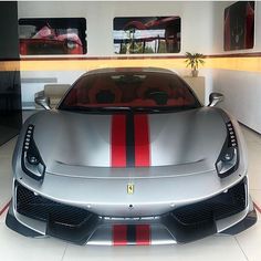 a silver sports car with red and black stripes