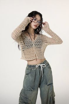 Experience the unique blend of comfort and style with our Crochet Crop Top, enriched with flare sleeves that exude a carefree spirit. Finely crafted with 100% polyester for durability, this cozy crop heading Top features a distinctive crochet pattern, adding a touch of texture and a flair to your wardrobe. Its loose knit design paired with flare sleeves offers both breathability and an edgy fashion statement, perfect for trendsetters. Pair it with high-waisted jeans or relaxed cargo pants for a laid-back look, or dress it up with a chic maxi skirt for an evening out. Ideal for a range of occasions, it embodies a fusion of freedom, passion, and creativity, making it more than just a piece of clothing - it's an attitude towards life. Product specifications: Material: 100 % PolyesterFit: Conv Trendy Open Knit Cropped Sweater For Summer, Beige Cropped Stretch Sweater For Spring, Beige Stretch Cropped Sweater For Spring, Chic Open Knit Cropped Sweater For Summer, Trendy Cropped Summer Cardigan, Trendy Long Sleeve Open Knit Crop Top, Casual Cropped Beige Cardigan, Casual Beige Cropped Cardigan, Cropped Sweater For Summer