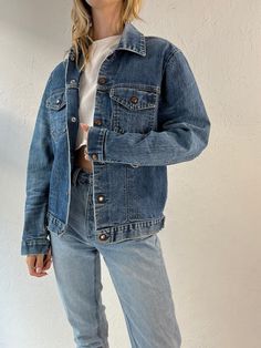 "- Vintage jean jacket - Significant wear throughout, including a few glue stains - Snaps up the front - No tags - Medium  Chest: 20\" Length: 24\" Sleeve: 25\"" Distressed Dark Wash Denim Jacket For Streetwear, Recycled Denim Jacket For Spring, Relaxed Fit Medium Wash Recycled Denim Jacket, Fall Medium Wash Recycled Denim Jacket, Medium Wash Everyday Denim Jacket, Everyday Distressed Medium Wash Denim Jacket, Everyday Light Wash Distressed Denim Jacket, Light Wash Recycled Denim Jacket For Streetwear, Distressed Dark Wash Denim Jacket For Fall