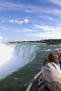 two people on a boat watching the water fall