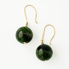 The rich, earthy green of chrome diopside is a true testament to nature's beauty. Found almost exclusively in eastern Siberia, chrome diopside is a rare gem due to the nearly year round frozen conditions. Chrome diopside can only be mined a few months each year! The chrome diopside gemstones are elegantly suspend from a delicate French ear wire, available in your choice of 14k gold or sterling silver. 💎Available in 14K gold (yellow, white, or rose) and sterling silver 💎French wire earring 💎Ch Classic Green Tourmaline Jewelry, Green Round Earrings For May Birthstone, Green Earrings For May Birthstone, Green Emerald Round Earrings, Classic Green Drop Earrings, Green Cabochon Round Earrings, Green Round Cabochon Earrings, Tsavorite Earrings For May Birthstone Gift, Tsavorite Earrings Gift For May Birthstone