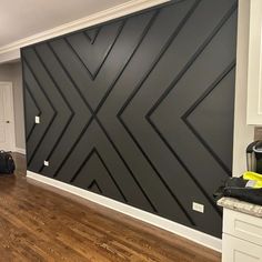 a room with hard wood flooring and black wall