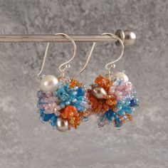 Lovely ball earrings with color power. Seed beads from Japan, freshwater pearls, a lot of different beads. Earrings are 4 cm long and the ball is 2,2 cm. Silver or gold plated hooks.  FAST SHIPPING   Need this item fast? We offer a Faster Shipping option here: https://www.etsy.com/shop/smykkeunivers/?etsrc=sdt&section_id=41039562 Europe 2-4 business days USA, Canada and rest of the world 4-7 business days Any questions, just ask. Unique Beaded Wedding Earrings, Multicolor Beaded Earrings For Wedding, Multicolor Crystal Earrings For Wedding, Handmade Fusion Style Bridal Drop Earrings, Handmade Multicolor Earrings For Anniversary, Handmade Dangle Cluster Earrings For Anniversary, Multicolor Drop Pearl Earrings For Wedding, Anniversary Beaded Dangle Earrings, Handmade Multicolor Drop Bridal Earrings