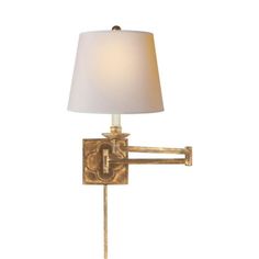 a wall light with a white shade on it's side and a gold finish