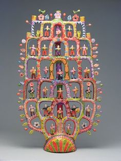 an elaborately decorated sculpture is displayed on a gray background