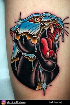 a tattoo with an image of a black and red snake biting into a heart on the thigh