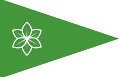 a green flag with a white flower on the front and bottom corner, which is outlined in white