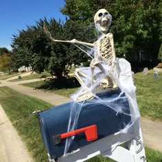 a skeleton mailbox decorated to look like a skeleton