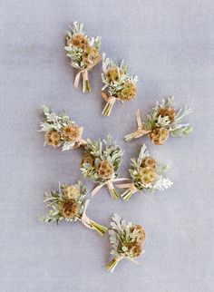 six bouquets of flowers are arranged in the shape of a circle on a gray background