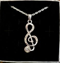 Treble clef necklace silver tone with rhinestone adjustable chain, 18- 20 inches new old stock vintage 1990s Beautiful Necklace  Perfect gift for musician  Nice adjustable chain Comes in a gift box As is Ships Immediately Silver Music-themed Metal Necklace, Nickel-free Silver Music-themed Necklaces, Treble Clef Necklace, Treble Clef, Beautiful Necklace, Necklace Silver, Silver Necklaces, Beautiful Necklaces, Jewelry Necklace Pendant