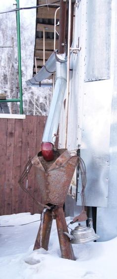 an old metal object sitting in the snow