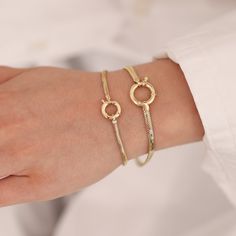 "Embrace the perfect fusion of sophistication and boldness with our exquisite 14K Gold Sailor Lock Snake Bracelet. Meticulously crafted with meticulous attention to detail, this bracelet showcases a distinctive sailor lock clasp, infusing a touch of nautical charm into its design. The sleek snake chain adds a contemporary and fashion-forward element, allowing for versatile styling options. Crafted from premium materials with unparalleled craftsmanship, this bracelet not only elevates your style Modern Gold Snake Chain Bracelet, Modern Flexible Bracelets For Anniversary, Modern Bracelets For Anniversary, Modern Flexible Jewelry For Wedding, Modern Flexible Wedding Jewelry, Modern Gold Bracelet With Jubilee Design, Modern Diamond Bracelet With Round Strap, Modern Round Diamond Bracelet With Strap, Modern Gold Jubilee Bracelet