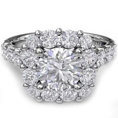 an engagement ring with three stone halos and round diamonds