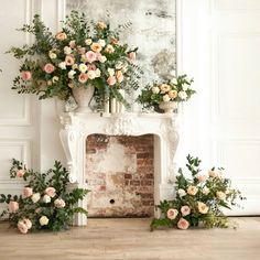 flowers and greenery are arranged in front of an old brick fireplace with white walls