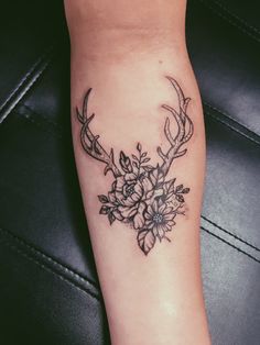 a deer's antlers with flowers on the arm