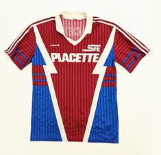 a red, blue and white soccer jersey with the word spacette on it's chest