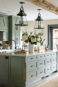 a large kitchen island with flowers on it and hanging lights over the counter top in front of an open door