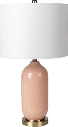 a pink table lamp with a white shade on the base and a gold metal base