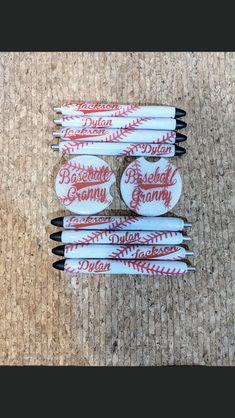 six baseball toothbrushes with red and white writing on them sitting on a carpet