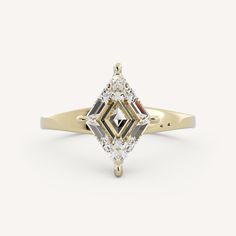 a yellow gold ring with a diamond cut in the center and two diamonds on each side