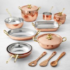 copper pots and pans with wooden spoons